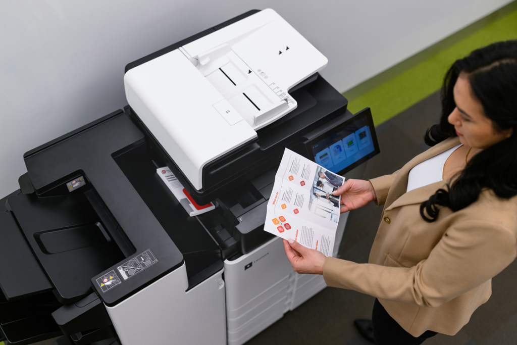 Female colleague using a multifunction printer